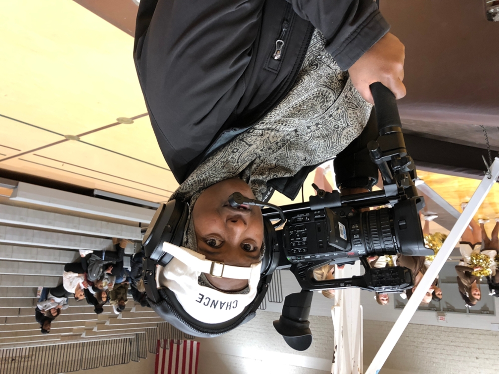Court side camera operator at the men's basketball game